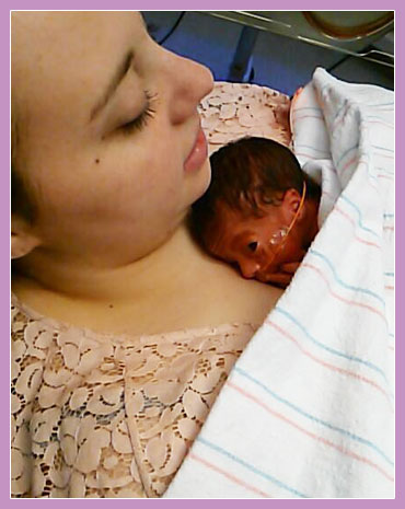 Photo of mother with premature child resting on her chest.