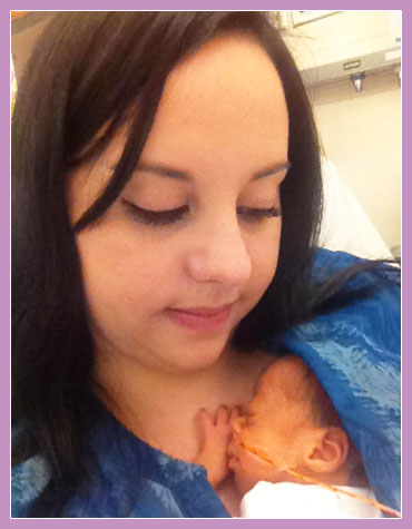 Photo of mother with baby snuggling into her chest.